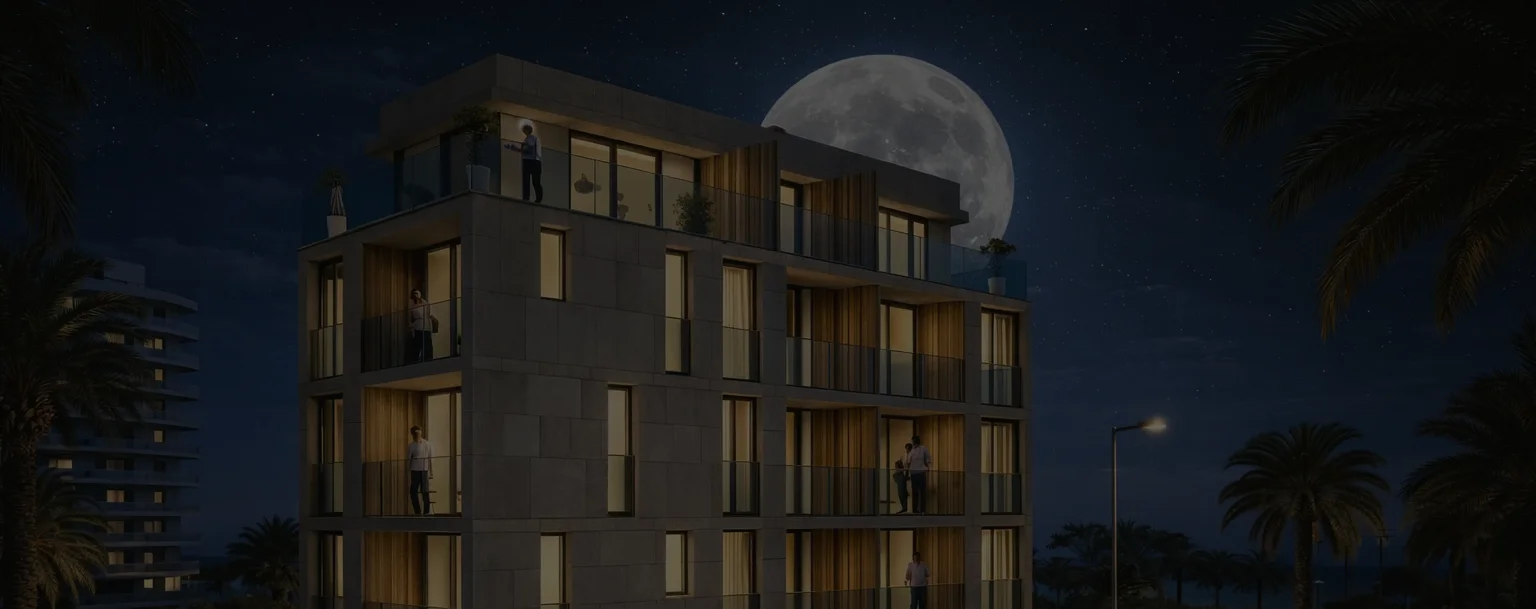 Edificio Vento at night — illuminated facade and rooftop solariums